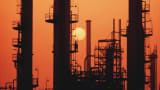 The sun sets over an oil refinery in Saudi Arabia.
