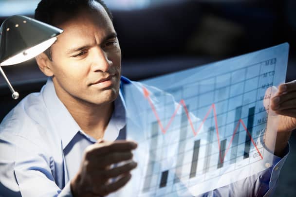 Premium: Man looking at graph investor