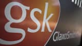 A GlaxoSmithKline logo sits on a sign outside the company's headquarters in London.