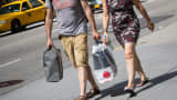 Shoppers walk down 5th Avenue in New York City.