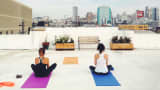 OpenDNS employees take Yoga lessons on their company rooftop.
