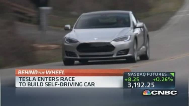 Tesla enters race to build self-driving car