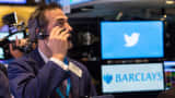A trader watches Twitter stock on the day of its IPO in 2013.