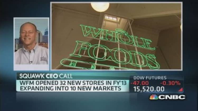 Whole Foods cuts outlook, plans expansion