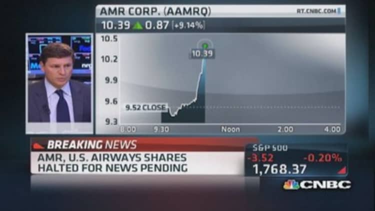 AMR, US Airways shares halted