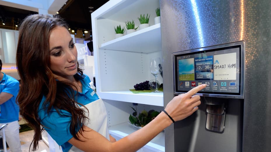 Samsung spokesperson displays the connectivity feature on a Samsung smart refrigerator at the 2014 International CES at the Las Vegas Convention Center.