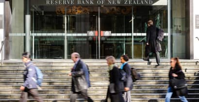New Zealand dollar jumps 1% as central bank holds rates, warns of more hikes