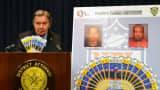 District Attorney Richard Brown displays counterfeit tickets seized days before the Super Bowl.