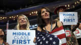 In this Sept. 5, 2012 at the Democratic National Convention in Charlotte, N.C. democratic supporters hold up signs showing their concern for the middle class.