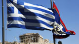 A Greek national flag, left, flies outside the Parthenon temple, on Acropolis hill, in Athens, Greece.