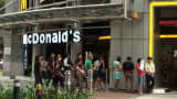 A queue forms outside of a McDonald's branch in Singapore on April 28, 2014.