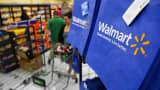 Walmart customers push carts past reusable shopping bags in Los Angeles.