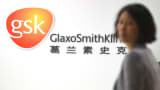 An employee of British drug firm GlaxoSmithKline (GSK) enters their office headquarters in Shanghai.