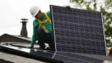 A SolarCity employee installs a solar panel on the roof of a home in the Eagle Rock neighborhood of Los Angeles.