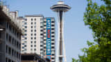 The Space Needle stands near newly constructed apartments in downtown Seattle.