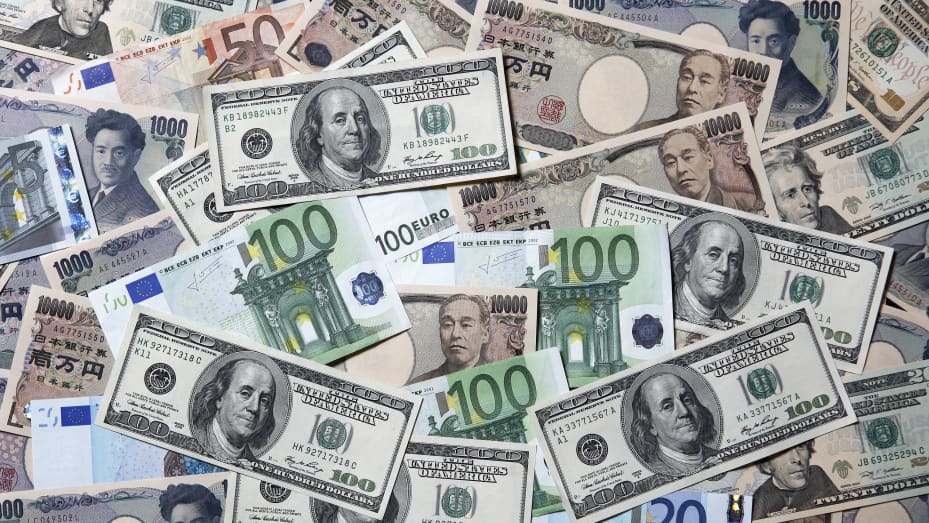 Yen, euro and U.S. dollar banknotes of various denominations.