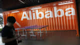 An employee walks past the Alibaba logo at the company’s headquarters outside of Hangzhou, China.