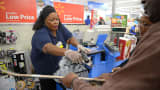 An employee rings up sales at a cash register of a Walmart store in Los Angeles.