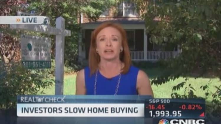 Investors slow home buying
