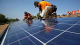 Technicians install solar panels on a house in Mission Viejo, Calif.