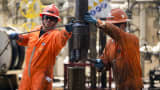 Oil workers change a drill pipe on n the Laurus oil drilling rig off the coast of Ciudad del Carmen, Mexico.