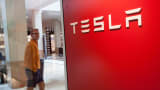 A man walks by a Tesla dealership in White Plains, New York.