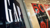 Sale signs are on display in the windows of a Gap retail location.