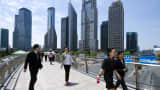 White-collars walk to their lunch break in Pudong business district in Shanghai, China.