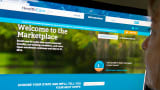 A woman looks at the HealthCare.gov insurance marketplace website in Washington.