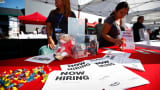Recruiters wait at a booth at a military veterans' job fair in Carson, Calif.