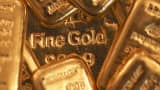 One-hundred-gram gold bars sit on a one-kilogram gold bar, center, at Gold Investments Ltd. bullion dealers in London, July 15, 2014.