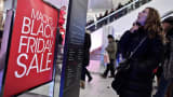 A woman looks for information at Macy's Herald Square in New York during a Black Friday sale.