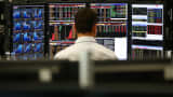 An employee views trading screens at the offices of Panmure Gordon and Co on October 20, 2014 in London, England.