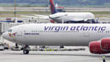 A Virgin Atlantic plane taxis past a Delta plane at John F. Kennedy International Airport in N.Y.