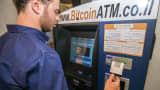 A Israeli man buys Bitcoins at a Bitcoin ATM machine in Tel Aviv.