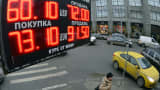 A board lists foreign currency rates against the Russian ruble outside an exchange office in central Moscow on Dec. 17, 2014.
