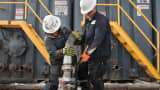 Workers from Select Energy Services at a Hess fracking site near Williston, N.D.