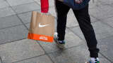 Shopper carrying a Nike shopping bag in New York.