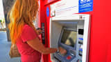 A customer uses a Bank of America ATM in Los Angeles.