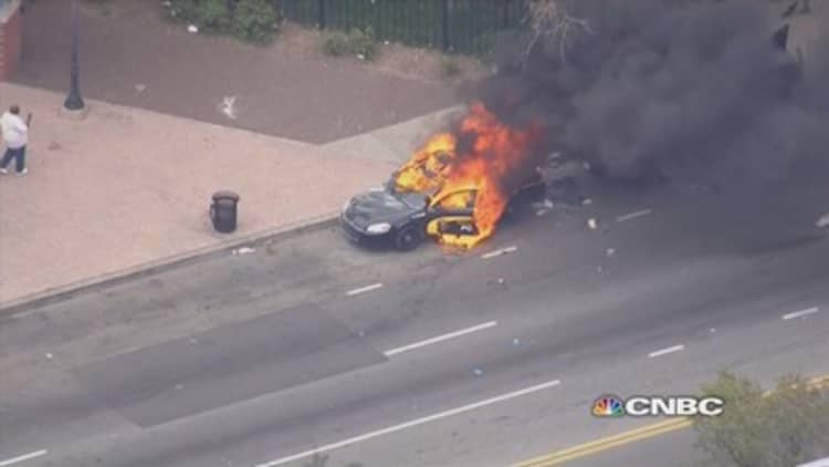 Baltimore protesters torch police car