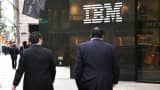 Pedestrians walk past the IBM building in New York.