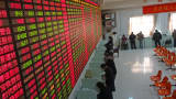 Investors check the share prices at a security firm in Shaoxing, China.