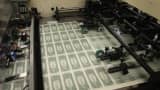 Sheets of one dollar bills run through the printing press at the Bureau of Engraving and Printing on March 24, 2015 in Washington, DC.