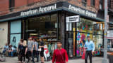 People walk past an American Apparel store in New York City.