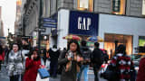 Pedestrians pass in front of a Gap store in New York.