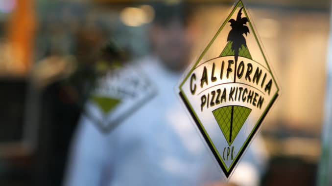 A chef walks towards the entrance of a California Pizza Kitchen Inc. restaurant in New York.
