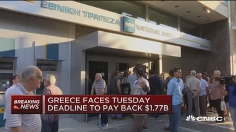 Greece shutters banks, limits ATM withdrawals