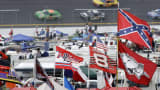 A Confederate flag flies in the infield as cars come out of turn one during a NASCAR auto race at Talladega Superspeedway in Talladega, Ala., Oct. 7, 2007.