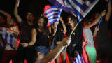 People celebrate in front of the Greek parliament as the people of Greece reject the debt bailout by creditors.