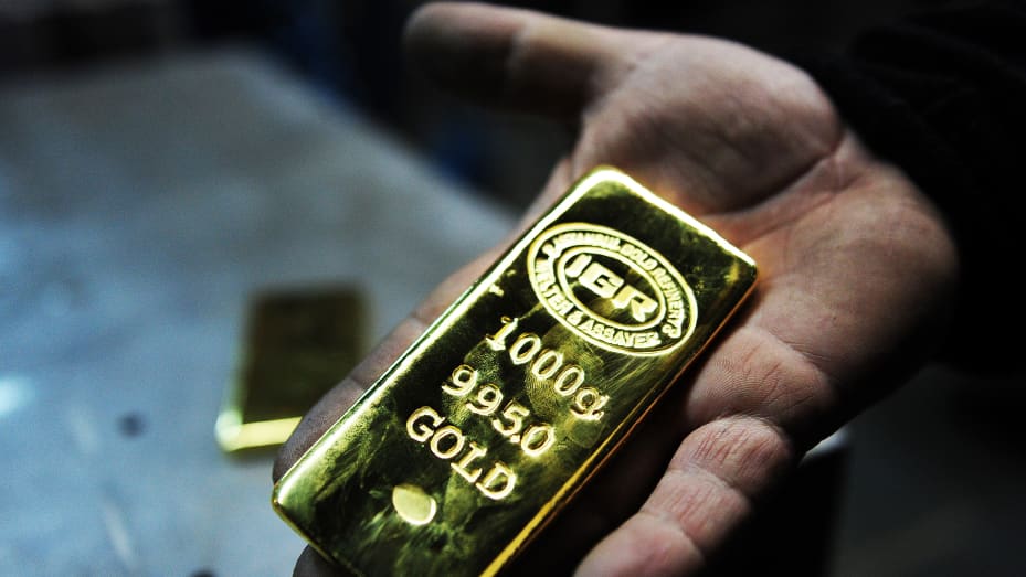 A gold worker holds a 1 KG gold bullion at Istanbul Gold Refinery (IGR) in Istanbul.